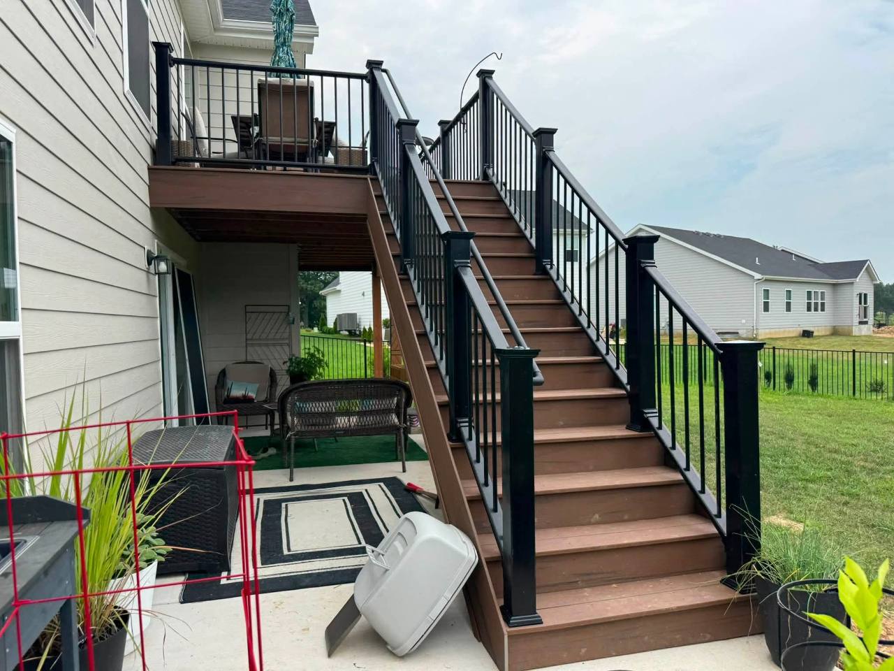 Wide composite stairway with black composite railing and aluminum spindles