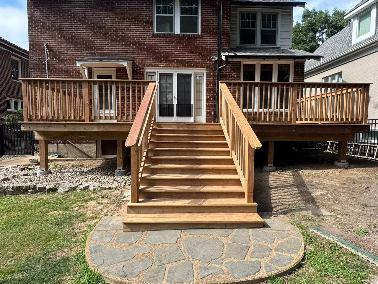 CedarTone deck with wide center stairs at a brick home