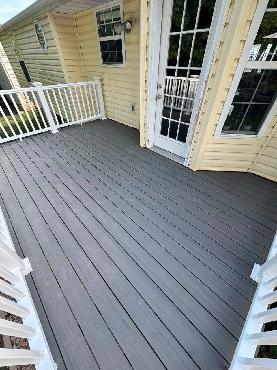 Gray composite decking and white vinyl railing