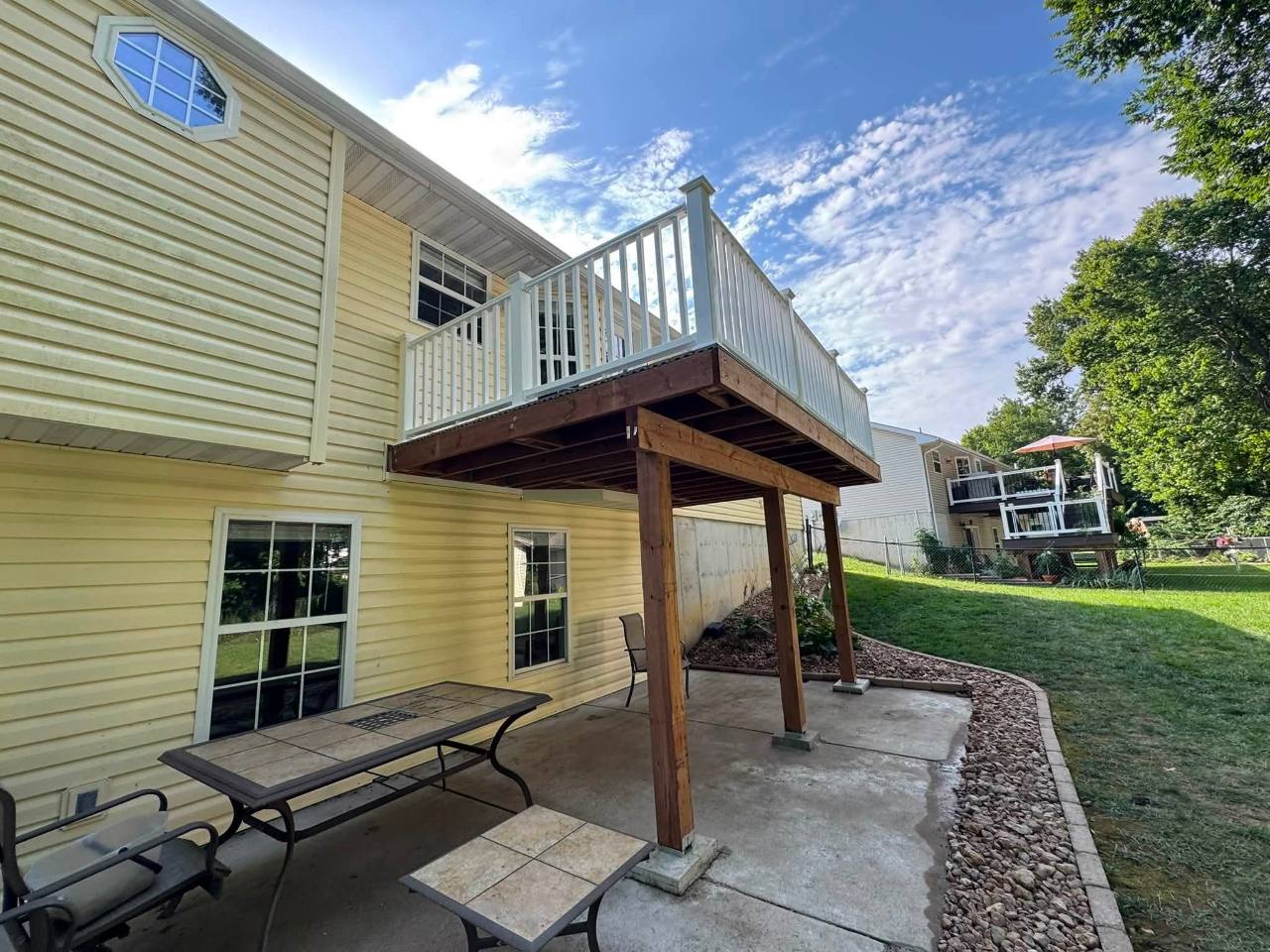 Finished elevated composite deck viewed from the patio