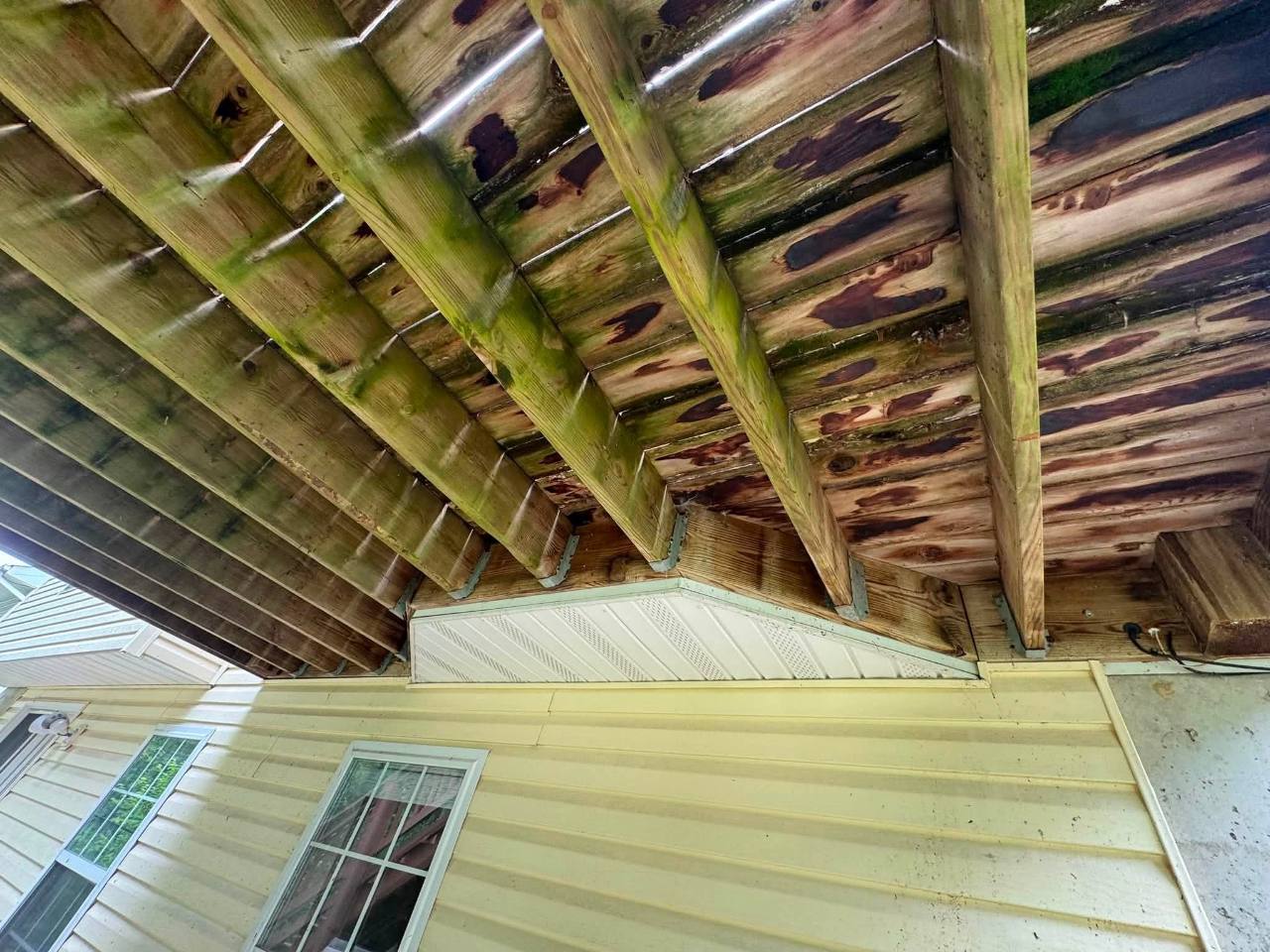 Weathered decking and framing before replacement
