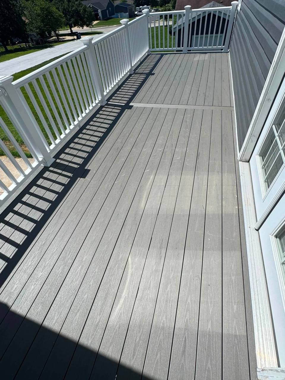 Gray composite deck surface with picture-frame divider